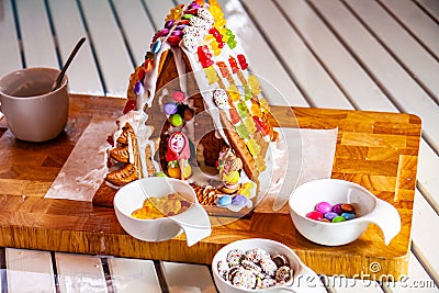 Familiy building a sweet ginger bread house Editorial Stock Photo