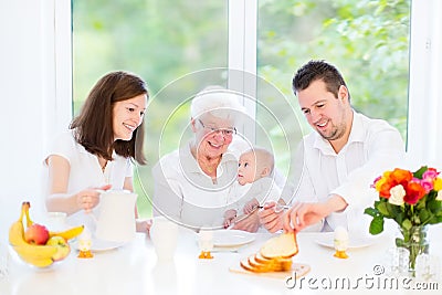 Family with baby having breakfast with drandmother Stock Photo