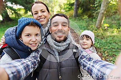 Family with backpacks taking selfie and hiking Stock Photo