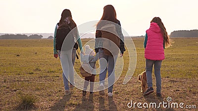 Family with backpacks travels with a dog. teamwork of a close-knit family. mother, daughters and home pets tourists Stock Photo