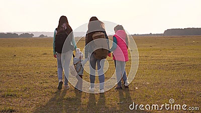 Family with backpacks travels with a dog. teamwork of a close-knit family. mother, daughters and home pets tourists Stock Photo