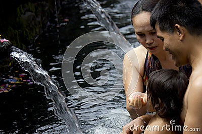 Family bathing at Sacred Fountains of Tirta Empul Editorial Stock Photo