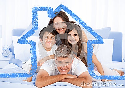 Family on bed together with house outline Stock Photo