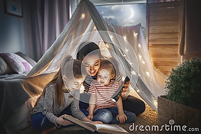 Mom and children reading book Stock Photo