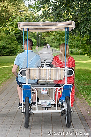 Family bicycle for four people and couples in love. Four wheels bicycle. Editorial Stock Photo