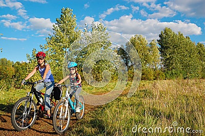 Family on bikes outdoors, active mother and kid cycling, fitness and healthy lifestyle Stock Photo