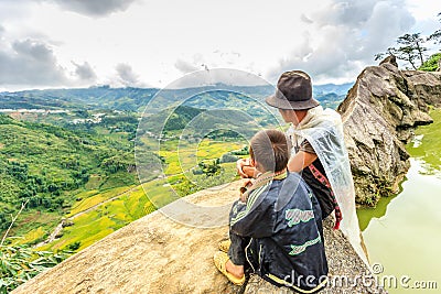 A family of the Black H'mong Ethnic Minority People sit on hill in Sapa, Vietnam on September 14, 2016 Editorial Stock Photo