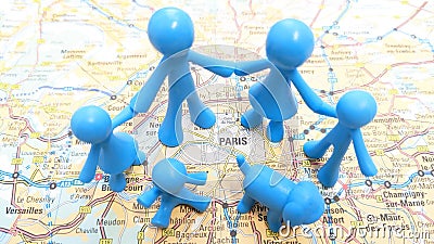 A family of blue toy figures holding hands exploring Paris Stock Photo
