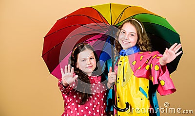 Family bonds. Little girls in raincoat. happy little girls with colorful umbrella. rain protection. Rainbow. autumn Stock Photo