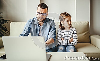 Family a businessman father working at a computer and his child daughter offended angry Stock Photo