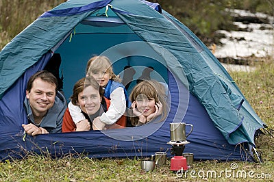 Family camping in tent Stock Photo
