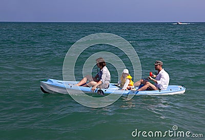 Family canoeing in the sea. Stock Photo