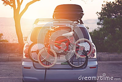 Family car with small kids bicycles rack, ready for travel, making a break on parking Stock Photo