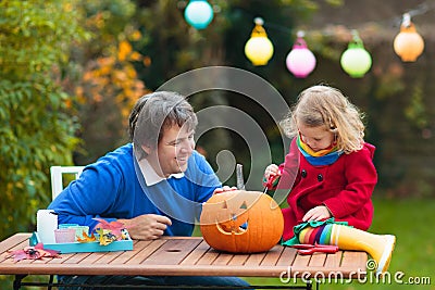 Family carving Halloween pumpkin Stock Photo