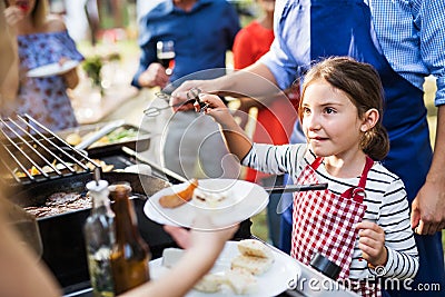 Family celebration or a barbecue party outside in the backyard. Stock Photo