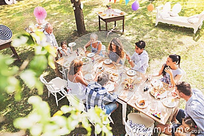 Family celebration or a garden party outside in the backyard. Stock Photo