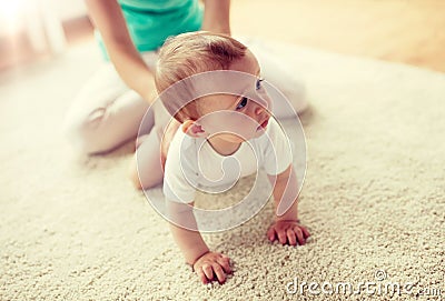 Mother with baby on floor at home Stock Photo