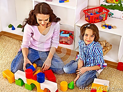 Family with child playing bricks. Stock Photo