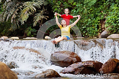 Family with child at waterfall. Travel with kids Stock Photo