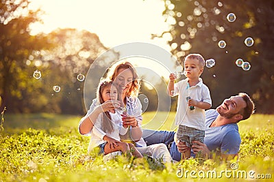 Family with children blow soap bubbles Stock Photo