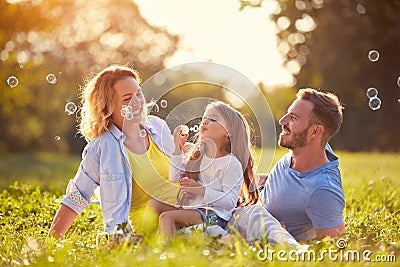 Family with children blow soap bubbles Stock Photo