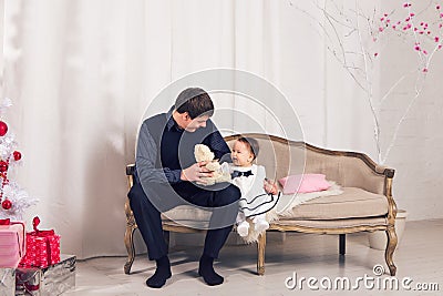 Family, children, christmas, x-mas, love concept - happy father with adorable baby daughter near christmas tree Stock Photo