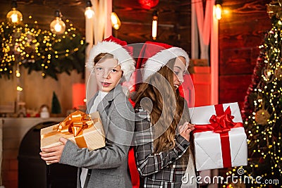 Family Christmas tradition. Kids lovely friends meet Christmas holiday. Sister and brother with gift boxes. Dreams come Stock Photo