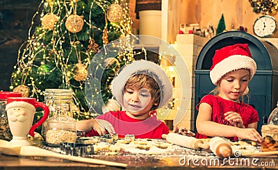 Family Christmas traditions. Children cooking for christmas. Funny children are preparing gingerbread for Christmas Stock Photo