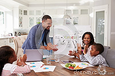 Family clapping at a domestic meeting in their kitchen Stock Photo
