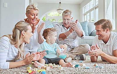 Family, clapping hands and baby playing with toys while sitting on the living room floor. Love, care and happy people Stock Photo