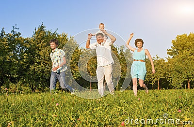 Family Concept and Ideas. Happy Family of Four Running Together Stock Photo