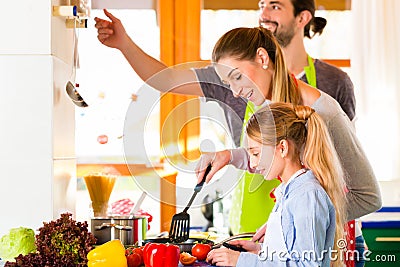 Family cooking in domestic kitchen healthy food Stock Photo