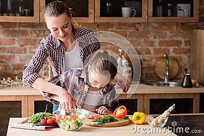 Family cooking mother teach daughter cut vegetable Stock Photo