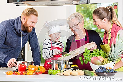 Family cooking in multigenerational household with son, mother, Stock Photo