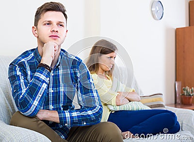 Family couple with serious faces quarrelling at home Stock Photo