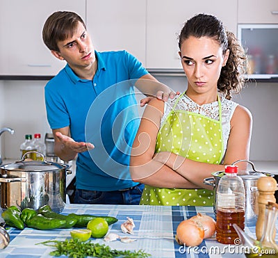 Family couple with serious faces quarrelling in kitchen Stock Photo
