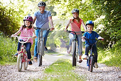 Family On Cycle Ride In Countryside Stock Photo