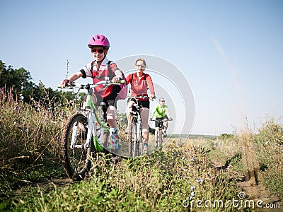 Family cycling outdoors Stock Photo