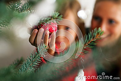 Family decorating Christmas tree Stock Photo