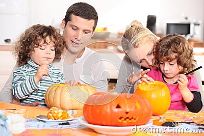 Family decorating pumpkins Stock Photo