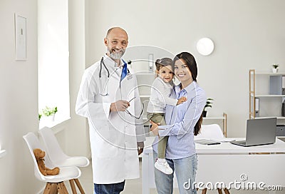 Family doctor. Mother and little girl patients visit to senior doctor at clinic office. Stock Photo