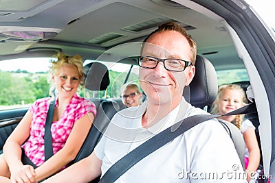 Family driving in car with seat belt Stock Photo
