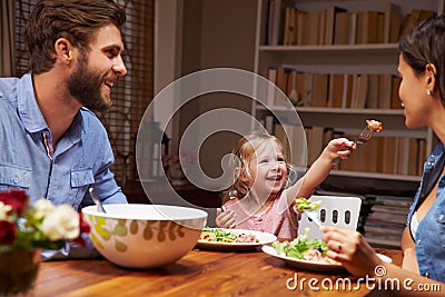Family eating an dinner at a dining table Stock Photo