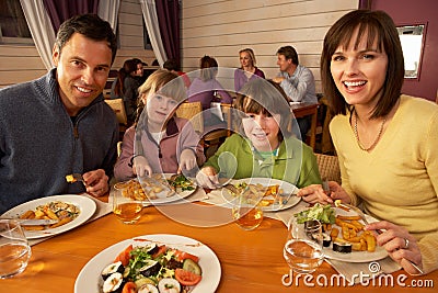 Family Eating Lunch Together In Restaurant Stock Photo