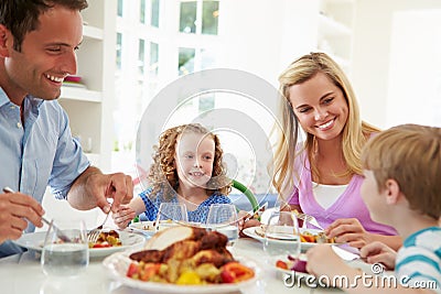 Family Eating Meal At Home Together Stock Photo