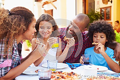 Family Eating Meal At Outdoor Restaurant Together Stock Photo