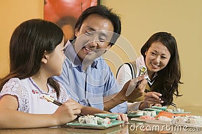 Family Eating Sushi Together Stock Photo