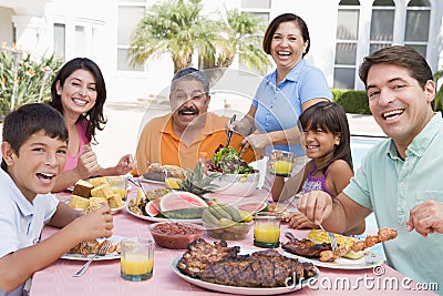 Family Enjoying A Barbeque Stock Photo