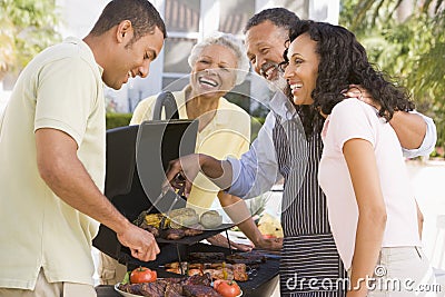 Family Enjoying A Barbeque Stock Photo