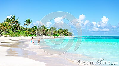 Family enjoying on the beautiful turquoise beach Editorial Stock Photo